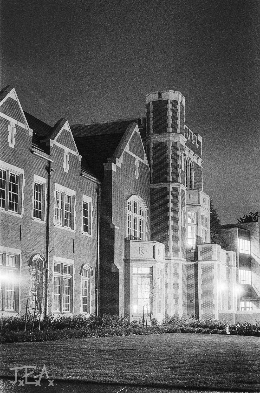 A black and white image of the University of Portland at night.