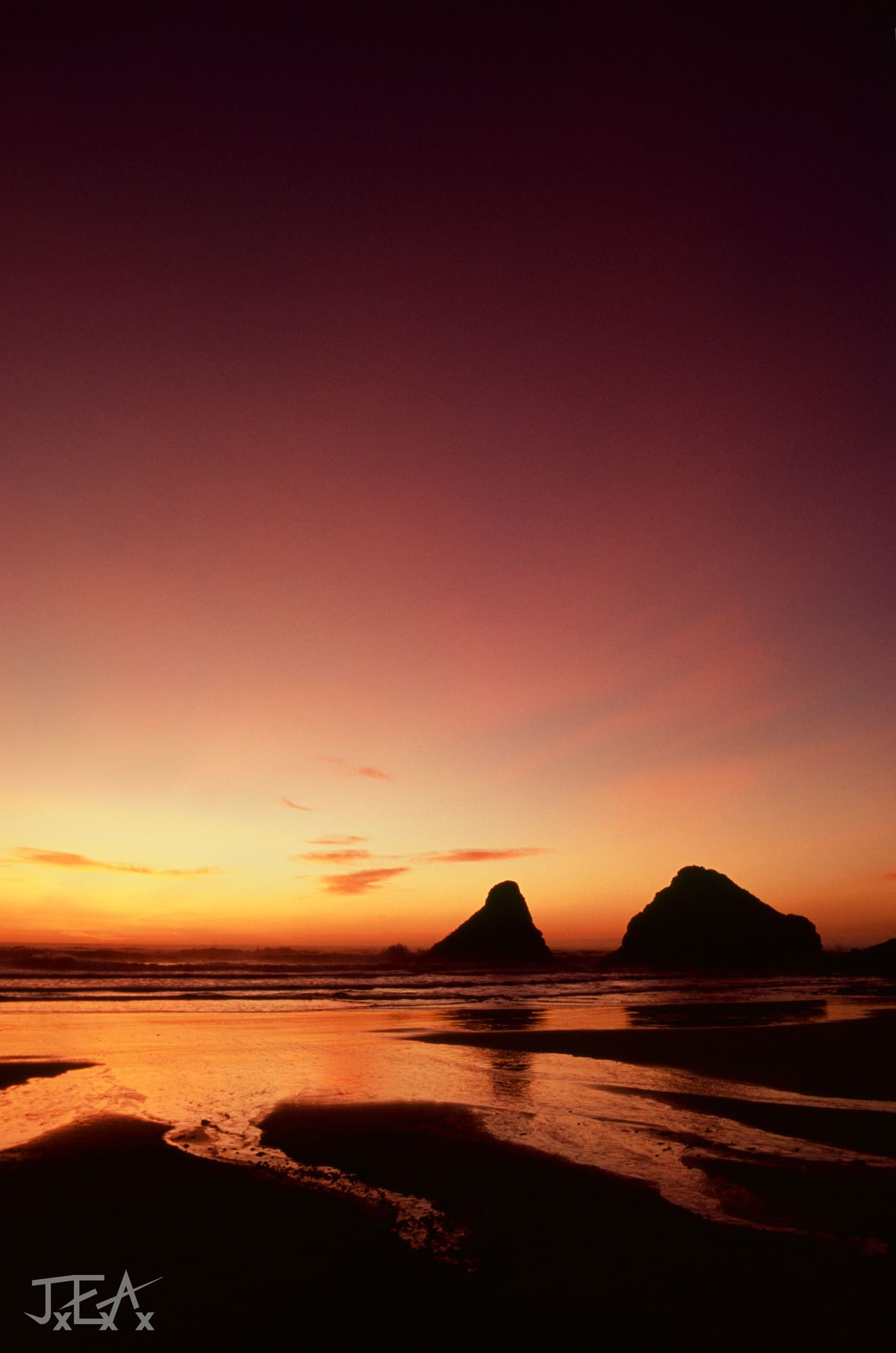 A fiery sunset at Cape Cove at the Heceta Head state viewpoint.