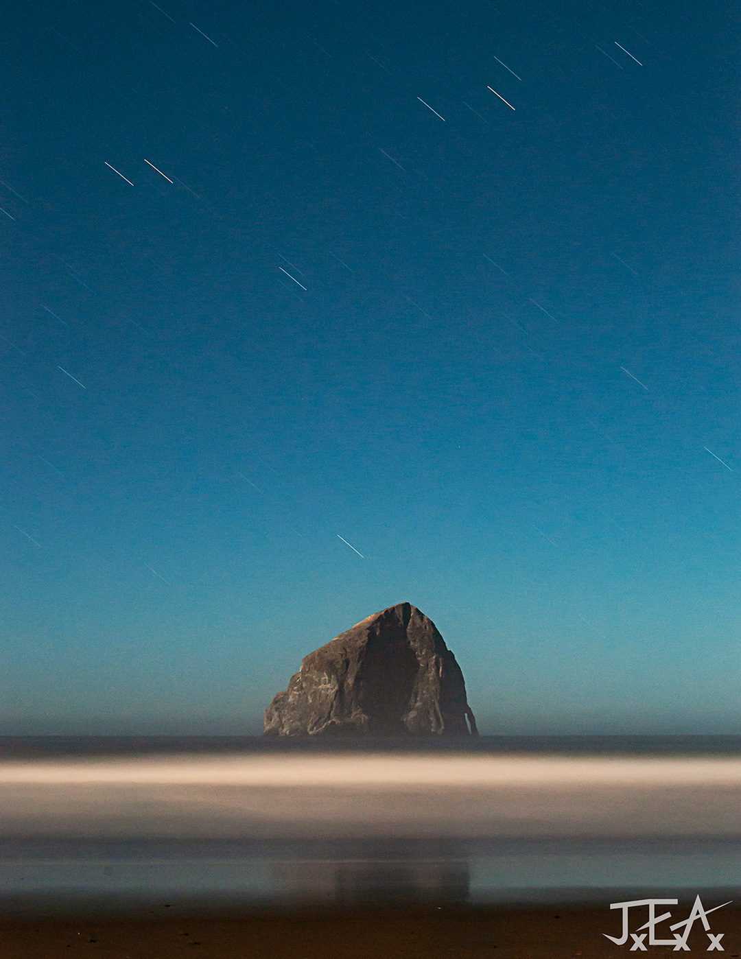 A Photo of Chief Kiwanda Rock at night from the beach in Pacific City Oregon.