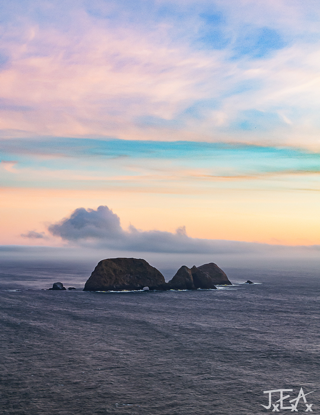 A wide shot of Three Arch Rocks National Wildlife Refuge from ontop of Cape Meares in Tillamook, Oregon.
