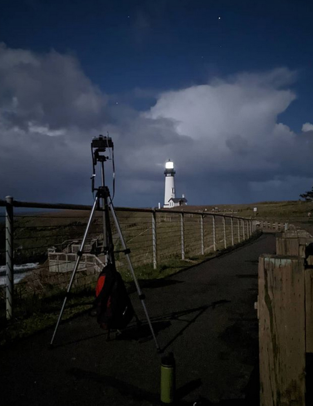 A behind the scenes shot showing my camera on its tripod with the lighthouse scene in the foreground.